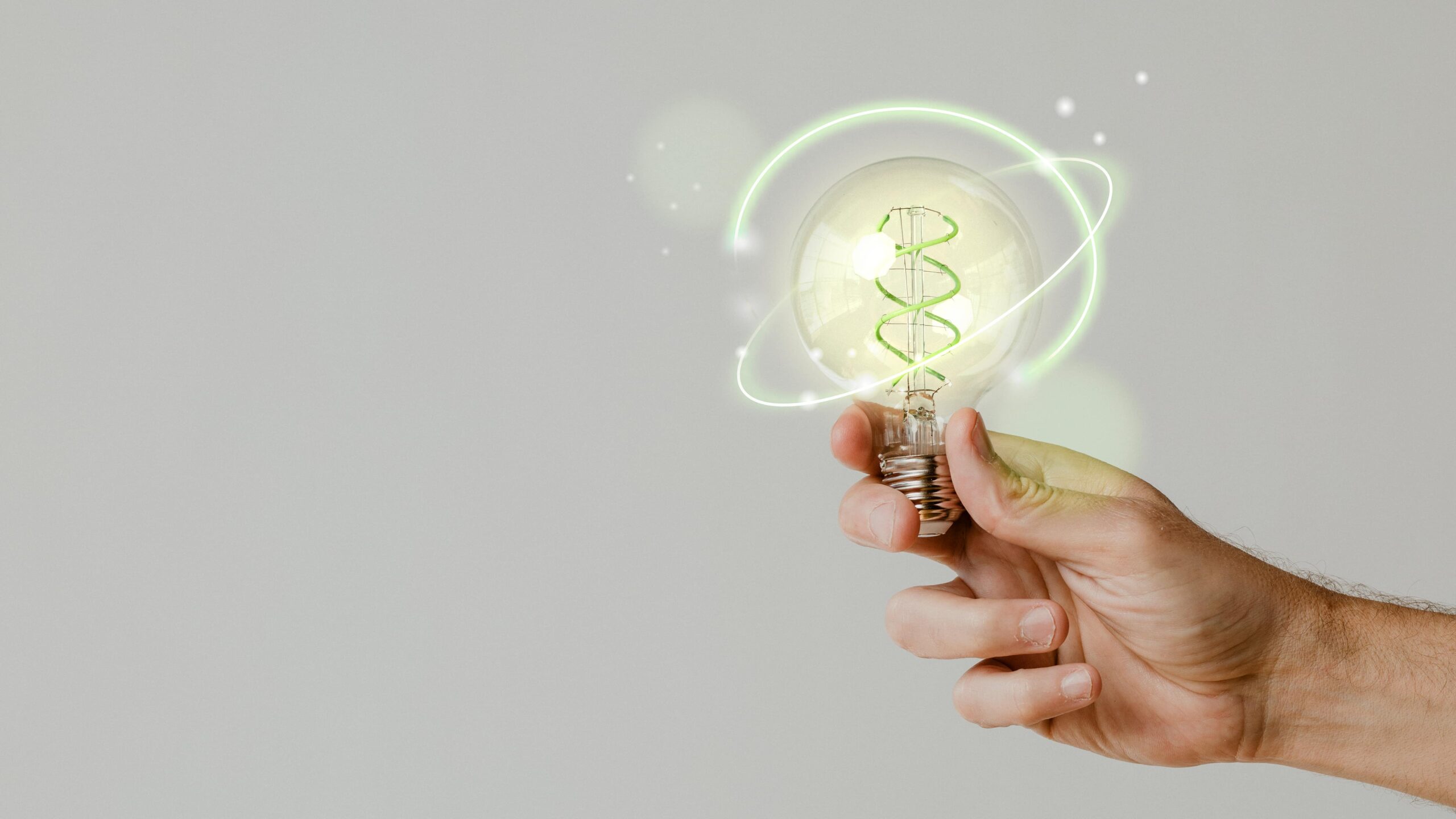 green energy with hand holding environmental light bulb background 1 scaled